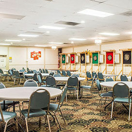 event space with large circle tables with chairs around